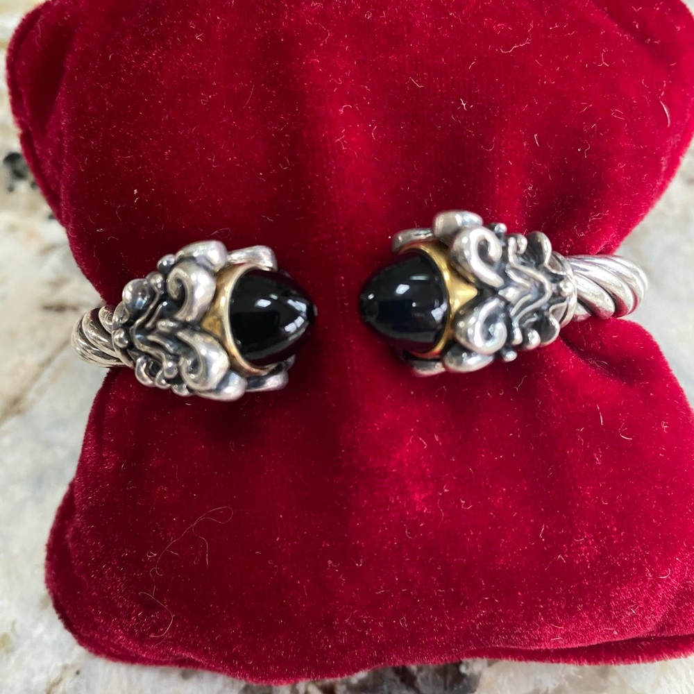 Sterling silver cuff bracelet with 14 karat gold and onyx highlights.